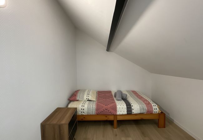 Chambre avec lit simple et rangement. 